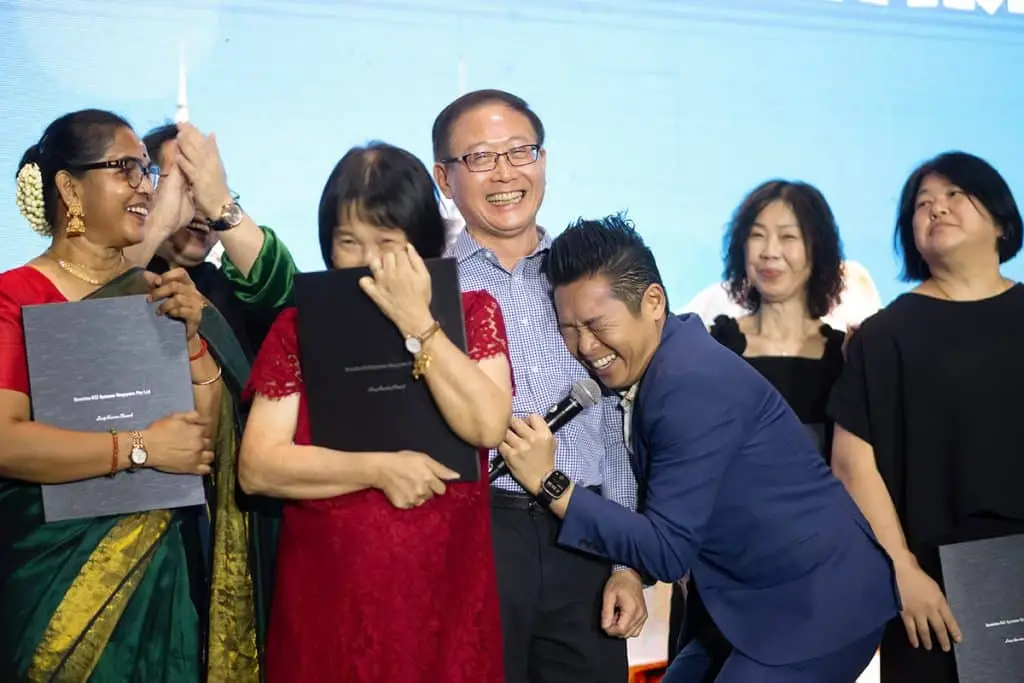 James Yang sharing a light moment with guests at an awards segment